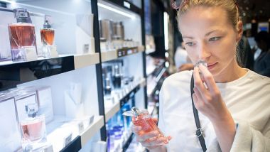 Woman smelling perfume onboard