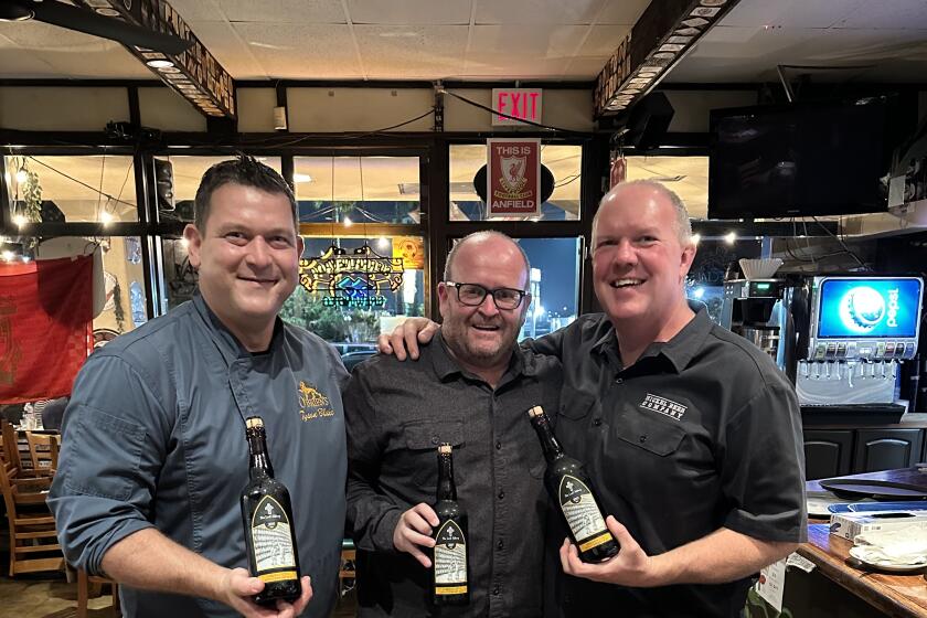 O'Brien's Pub co-owners Tyson Blake, left, and Tom Nickel, right, with Lost Abbey brewer Tomme Athur, center. The 30-year-old Kearny Mesa pub was just named the No. 1 beer bar in America by USA Today.