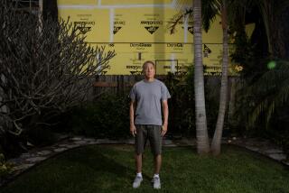 San Diego, California - May 02: Marc Umemoto stands in his backyard, behind him is his neighbor's property where an accessory dwelling unit is being built in Crown Point on Thursday, May 2, 2024 in San Diego, California. (Ana Ramirez / The San Diego Union-Tribune)